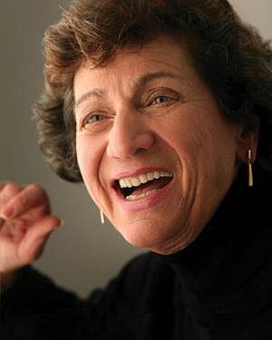 Kay Mouradian smiling and speaking.
