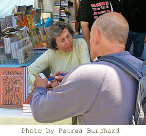 Kay Mouradian speaking with a reader at a book-signing table. Photograph by Petrea Burchard.